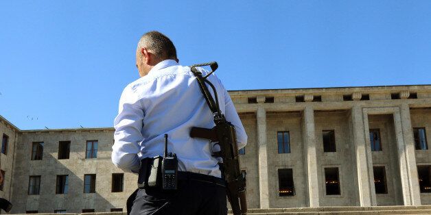 A special police force member stands in front of the parliament near the Turkish military headquarters, in Ankara, Turkey, Saturday, July 16, 2016. Forces loyal to Turkey's President Recep Tayyip Erdogan quashed a coup attempt in a night of explosions, air battles and gunfire that left dozens dead Saturday. Authorities arrested thousands of people as President Recep Tayyip Erdogan vowed those responsible