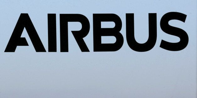 People speak together near a logo of Airbus Group during the Airbus annual news conference in Colomiers, near Toulouse, January 13, 2015. REUTERS/Regis Duvignau/File Picture