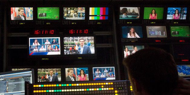 Alexis Tsipras, Greece's prime minister, center, is seen on television monitors in the television production gallery ahead of a news broadcast by Skai Television, operated by the Skai Group, in Piraeus, Greece, on Sunday, July 12, 2015. European finance chiefs said they were unlikely to strike a deal on the outlines of a third Greek bailout, threatening to delay the cash infusion Prime Minister Alexis Tsipras desperately needs. Photographer: Simon Dawson/Bloomberg via Getty Images