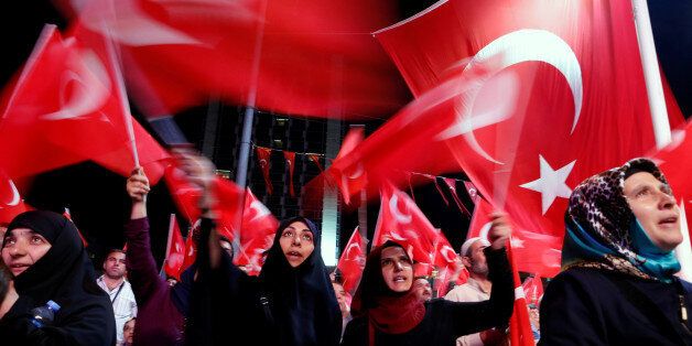 Supporters of Turkish President Tayyip Erdogan wave Turkish flags during a pro-government demonstration at Taksim square in central Istanbul, Turkey, July 19, 2016.REUTERS/Ammar Awad
