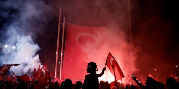A young boy waves a Turkish national flag as supporters of Turkish President Tayyip Erdogan gather during a pro-government demonstration on Taksim square in Istanbul, Turkey, July 18, 2016. Picture taken July 18, 2016. REUTERS/Alkis Konstantinidis