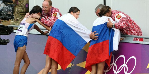 FILE - In this Aug. 11, 2012 file photo Russia coach Alexey Melnikov congratulates Olga Kaniskina, right, and Russia men's gold medalist Sergey Kirdyapkin congratulates Anisya Kirdyapkina, left, after the women's 20-kilometers race walk at the 2012 Summer Olympics in London. Russia gold-medalist Elena Lashmanova stands at center. Track and field's world governing body is meeting Friday, June 17, 2016 to decide whether to allow Russian track and field athletes to compete in the Rio de Janeiro Olympics. The IAAF's ruling council convened in Vienna on Friday to consider whether to uphold or lift the suspension of Russia's track and field federation. (AP Photo/Sergei Grits, file)