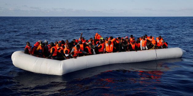 Migrants in a dinghy await rescue by the Migrant Offshore Aid Station (MOAS) around 20 nautical miles off the coast of Libya, June 23, 2016. Picture taken June 23, 2016. REUTERS/Darrin Zammit Lupi MALTA OUT. NO COMMERCIAL OR EDITORIAL SALES IN MALTA