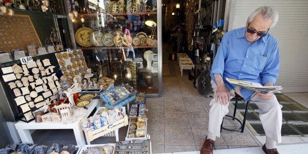 A vendor waits for customers in his shop at Monastiraki area in central Athens, Greece, July 7, 2015. Greece faces a last chance to stay in the euro zone on Tuesday when Prime Minister Alexis Tsipras puts proposals to an emergency euro zone summit after Greek voters resoundingly rejected the austerity terms of a defunct bailout. REUTERS/Jean-Paul Pelissier