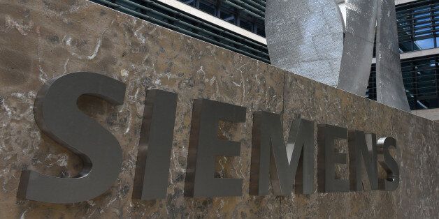 German engineering giant Siemens' logo is pictured in front of the main entrance of the new headquarters in Munich, southern Germany, on June 14, 2016. The new building designed and built in the past six years, will provide jobs for 1,200 employees and will be officially opened at the end of June 2016. / AFP / CHRISTOF STACHE (Photo credit should read CHRISTOF STACHE/AFP/Getty Images)