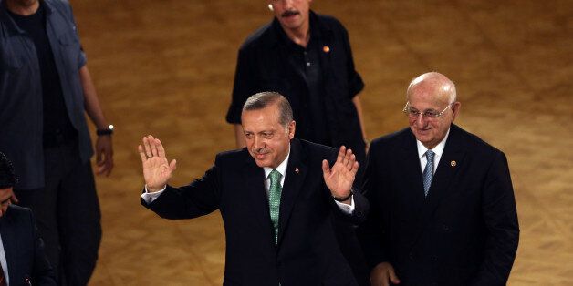 Turkey's President Recep Tayyip Erdogan salutes after his address at the parliament in Ankara, Turkey, Friday, July 22, 2016. Parliament voted 346-115 to approve the national state of emergency, which gives sweeping new powers to President Recep Tayyip Erdogan, who had been accused of autocratic conduct even before this week's crackdown on alleged opponents. Erdogan has said the state of emergency will counter threats to Turkish democracy. (AP Photo/Burhan Ozbilici)