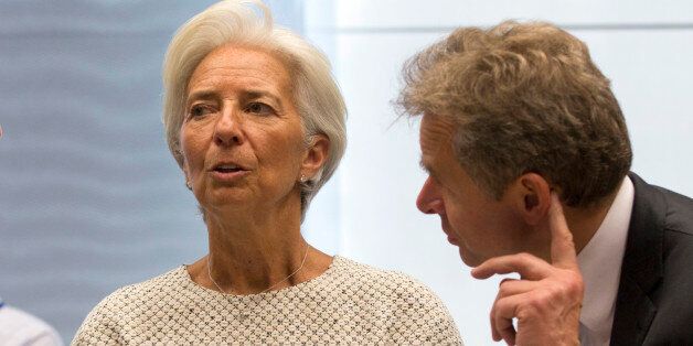 Managing Director of the International Monetary Fund Christine Lagarde, center, speaks with Director of the IMF's European Department Poul M. Thomsen during a meeting of eurozone finance ministers at the EU Lex building in Brussels on Saturday, July 11, 2015. Greece's negotiators head to Brussels on Saturday armed with their reform proposals and parliamentary backing to seek a third bailout, but with the shadow of severe dissent from governing lawmakers hanging over them. (AP Photo/Virginia Mayo)