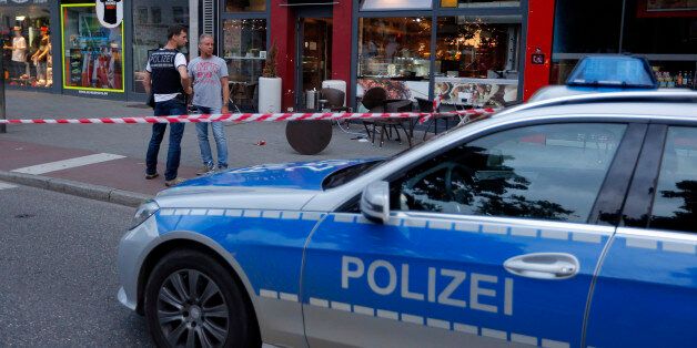 Police patrol outside where a 21-year-old Syrian refugee killed a woman with a machete and injured two other people in the city of Reutlingen, Germany July 24, 2016. REUTERS/Vincent Kessler