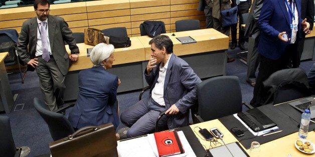 Greek Finance Minister Euclid Tsakalotos. center right, speaks with Managing Director of the International Monetary Fund Christine Lagarde, center left, during a round table meeting of eurogroup finance ministers at the EU Lex building in Brussels on Sunday, July 12, 2015. Greece has another chance Sunday to convince skeptical European creditors that it can be trusted to enact wide-ranging economic reforms which would safeguard its future in the common euro currency. (AP Photo/Michel Euler)