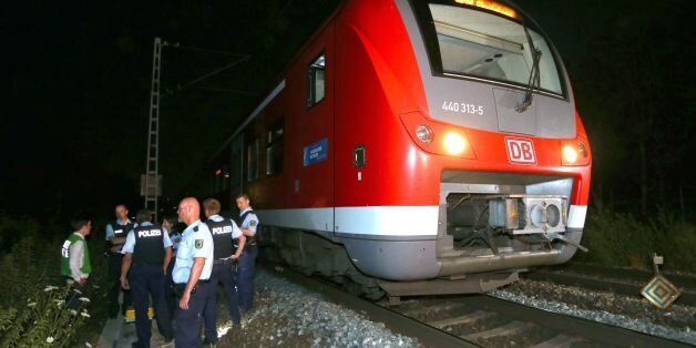 Police officers stand by a regional train in Wuerzburg southern Germany on July 18, 2016 after a man attacked train passengers with an axe. German police killed the man after he attacked passengers on a train with an axe and a knife, seriously wounding three people, news agency DPA reported citing police. / AFP / dpa / Karl-Josef Hildenbrand / Germany OUT (Photo credit should read KARL-JOSEF HILDENBRAND/AFP/Getty Images)