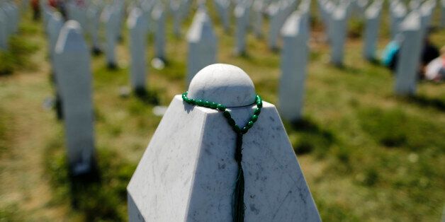A rosary is placed on a tombstone at the Memorial Center Potocari, near Srebrenica, Bosnia and Herzegovina July 11, 2015. The bodies of the 136 recently identified victims of Srebrenica massacre are buried in Potocari during ceremonies to mark the 20th anniversary of the massacre. Abandoned by their U.N. protectors toward the end of a 1992-95 war, 8,000 Muslim men and boys were executed by Bosnian Serb forces over five July days, their bodies dumped in pits then dug up months later and scattered in smaller graves in a systematic effort to conceal the crime. REUTERS/Antonio Bronic