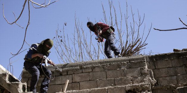Militants from the Kurdistan Workers' Party, or PKK, run as they attack Turkish security forces in Nusaydin, Turkey, Tuesday, March 1, 2016. Turkish authorities say a curfew in the district of Cizre in the southeastern province of Sirnak will be lifted at 5 a.m. on Wednesday. The curfew was declared on Dec. 14, coupled with large-scale military operations to flush out Kurdish militants who set up ditches and trenches to keep security forces at bay.(AP Photo/Cagdas Erdogan)
