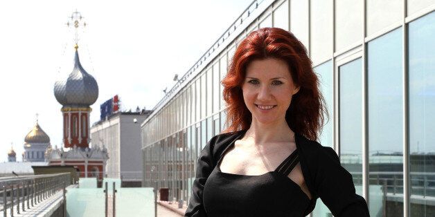 Anna Chapman, the former Russian spy, poses for a photograph against the Moscow skyline following an interview at an office in Moscow, Russia, on Friday, June 3, 2011. 'I've always been fascinated with technology,' Chapman, 29, said in an interview in Bloomberg via Getty Images News' Moscow office yesterday. Photographer: Andrey Rudakov/Bloomberg via Getty Images