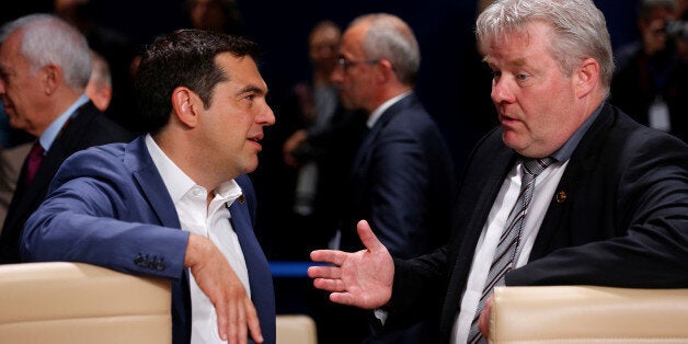 Greece's Prime Minister Alexis Tsipras and Iceland's Prime Minister Sigurdur Ingi Johannsson arrive for a working session of the North Atlantic Council at the NATO Summit in Warsaw, Poland July 9, 2016. REUTERS/Jonathan Ernst