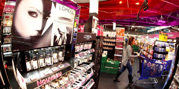 A customer walks past a cosmetic display of French cosmetics group L'Oreal at a Carrefour hypermarket in Nice, France, April 6, 2016. REUTERS/Eric Gaillard