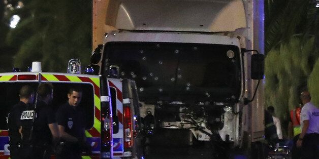 Police officers stand near a van, with its windscreen riddled with bullets, that ploughed into a crowd leaving a fireworks display in the French Riviera town of Nice on July 14, 2016.Up to 30 people are feared dead and over 100 others were injured after a van drove into a crowd watching Bastille Day fireworks in the French resort of Nice on July 14, a local official told French television, describing it as a 'major criminal attack'. / AFP / VALERY HACHE (Photo credit should read VALERY HACHE/AFP/Getty Images)
