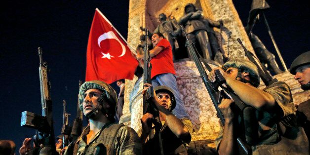 Turkish soldiers secure the area as supporters of Turkey's President Recep Tayyip Erdogan protest in Istanbul's Taksim square, early Saturday, July 16, 2016. Turkey's prime minister says a group within Turkey's military has engaged in what appeared to be an attempted coup. Binali Yildirim told NTV television: