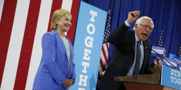 Democratic presidential candidate Hillary Clinton listens as Sen.Bernie Sanders, I-Vt. speaks during a rally in Portsmouth, N.H., Tuesday, July 12, 2016, where Sanders endorsed Clinton. (AP Photo/Andrew Harnik)