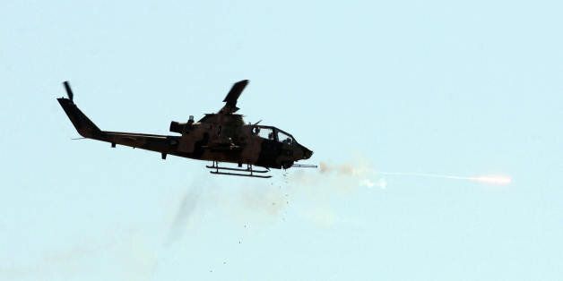 A combat Cobra helicopter fires during an Efes-2009 Military Exercise in Izmir on May 26, 2009. Turkish Prime minister Recep Tayyip Erdogan and Chief of Staff General Ilker Basbug attended the exercises. AFP PHOTO/ADEM ALTAN (Photo credit should read ADEM ALTAN/AFP/Getty Images)