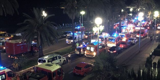 Security and medical teams work on the famed Promenade des Anglais, scene of the truck attack, in Nice, southern France, early Friday, July 15, 2016. A large truck mowed through revelers gathered for Bastille Day fireworks in Nice, killing dozens of people and sending people fleeing into the sea as it bore down for more than a mile along the Riviera city's famed waterfront promenade. (AP Photo/Sinan Baykent)