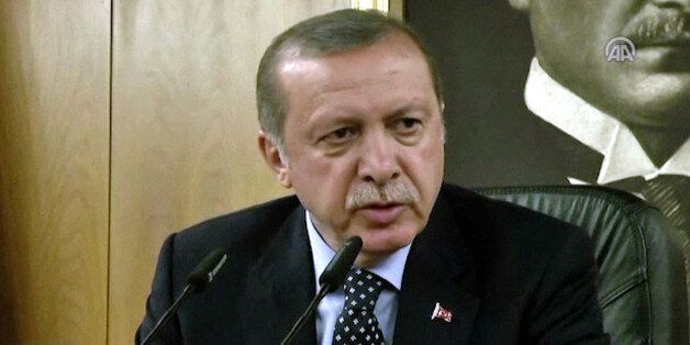 In this image taken from video provided by Anadolu Agency, Turkish President Recep Tayyip Erdogan speaks to the media Saturday, July 16, 2016 in Istanbul. Erdogan said that his government was working to crush a coup attempt after a night of explosions, air battles and gunfire that left dozens dead and at least 150 people wounded. (Anadolu Agency via AP)