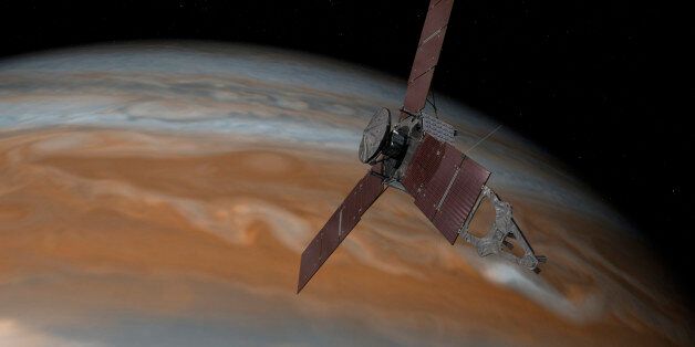 This artist's rendering provided by NASA and JPL-Caltech shows the Juno spacecraft above the planet Jupiter. Five years after its launch from Earth, Juno is scheduled to go into orbit around the gas giant on Monday, July 4, 2016. (NASA/JPL-Caltech via AP)