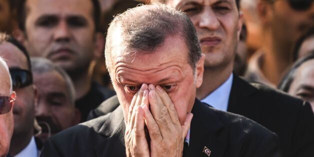 Turkey's President Recep Tayyip Erdogan (C) reacts after attending the funeral of a victim of the coup attempt in Istanbul on July 17, 2016. Turkish President Recep Tayyip Erdogan vowed today to purge the 'virus' within state bodies, during a speech at the funeral of victims killed during the coup bid he blames on his enemy Fethullah Gulen. / AFP / BULENT KILIC (Photo credit should read BULENT KILIC/AFP/Getty Images)