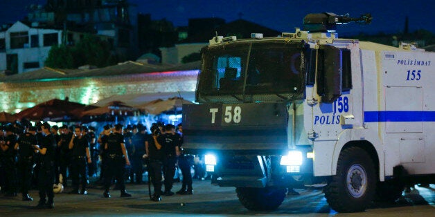 Turkish police officers stand by a car near the Taksim Square in Istanbul, Turkey, July 15, 2016. REUTERS/Murad Sezer