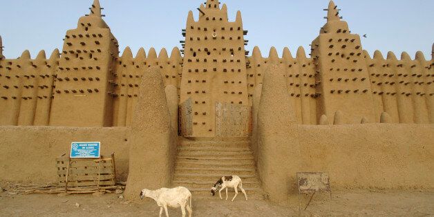 The Great Mosque of Djenne is the largest mud brick building in the world with definite Islamic influences. The mosque is located in the city of Djenne, Mali on the flood plain of the Bani River. The first mosque on the site was built in the 13th century, but the current structure dates from 1907. As well as being the centre of the community of DjennÃ©, it is one of the most famous landmarks in Africa. Along with the 'Old Towns of DjennÃ©' it was designated a World Heritage Site by UNESCO in