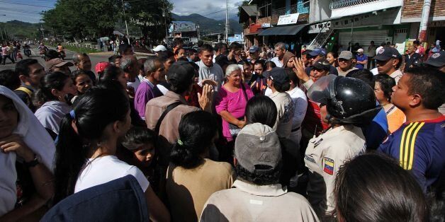 People protest for the lack of food, in San Cristobal, Tachira state, in the border with Colombia on June 16, 2016. The US and Venezuelan governments said Tuesday they would launch new high-level talks as the South American country struggles with a political and economic crisis. / AFP / George Castellano (Photo credit should read GEORGE CASTELLANO/AFP/Getty Images)