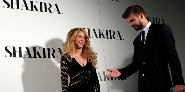 Colombian singer Shakira and Barcelona's soccer player Gerard Pique (R) pose during a photocall presenting her new album