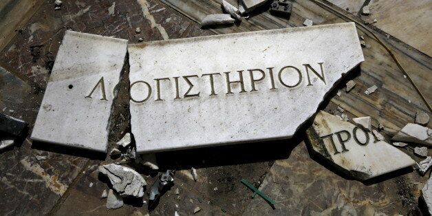 A broken marble sign that reads