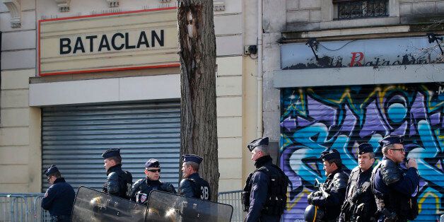 Riot police officers guard the Bataclan concert hall in Paris, Thursday, March 17, 2016. French lawmakers leading an investigation into the Nov. 13 attacks and some of the first responders at the Bataclan concert hall that night returned Thursday to re-enact the horror that left a total of 130 people dead across Paris. (AP Photo/Michel Euler)