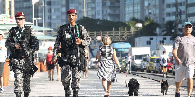 RIO DE JANEIRO, BRAZIL - JULY 05: Brazilian National Force soldiers patrol along Copacabana beach, a venue site for the Rio 2016 Olympic Games, on July 5, 2016 in Rio de Janeiro, Brazil. National Force soldiers assumed security control of all the Rio Olympic venue sites today-one month before the start of the games. (Photo by Mario Tama/Getty Images)
