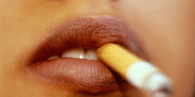 WOMANS MOUTH SMOKING CIGARETTE
