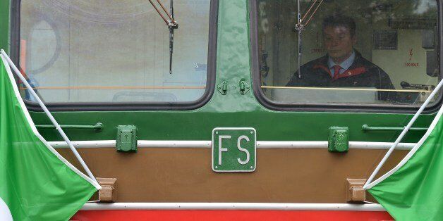 The driver of the Tuscany's touristic train is pictured on April 11, 2015 near Montalcino. Italian Culture Minister Dario Franceschini presented a new strategy for sustainable tourism aboard an antic train of the Ferrovie dello Stato Italiane (FS) dating back to 1920. The Tuscany's Nature Train is part of the 'slow tourism' project with a route along the Val dOrcia region, the Crete Senesi and their typical Tuscanys landscapes. AFP PHOTO / TIZIANA FABI (Photo credit should read TIZIANA FABI/AFP/Getty Images)