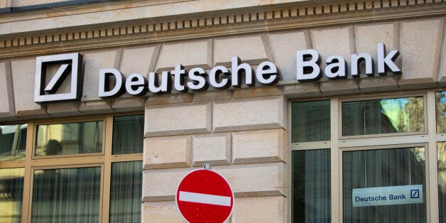 Deutsche Bank AG signage sits on the facade of a branch above a no entry sign, in Hamburg, Germany, on Saturday, Feb. 13, 2016. Deutsche Bank plans to buy back about $5.4 billion of bonds in euros and dollars as it seeks to allay investor concerns about its finances. Photographer: Krisztian Bocsi/Bloomberg via Getty Images