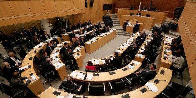 Lawmakers participate in a parliamentary session in Nicosia March 22, 2013. Cyprus's parliament adopted laws on Friday creating a