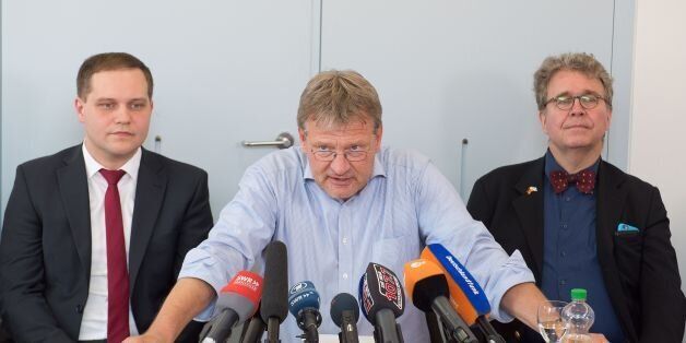 Joerg Meuthen (C), parliamentary group leader of the right-wing populist party AfD (Alternative for Germany) in the regional parliament of Baden-Wuerttemberg, southern Germany, is flanked by AfD parliamentary group members Anton Baron (L) and Heinrich Fiechtner as he gives a press conference on July 5, 2016 at the regional parliament in Stuttgart.Meuthen and twelve AfD delegates left their parliamentary group after another parliamentary group member, Wolfgang Gedeon, had made anti-Semitic remarks. The incident has triggered a power struggle in the party's leadership. / AFP / dpa / Bernd WEISSBROD / Germany OUT (Photo credit should read BERND WEISSBROD/AFP/Getty Images)