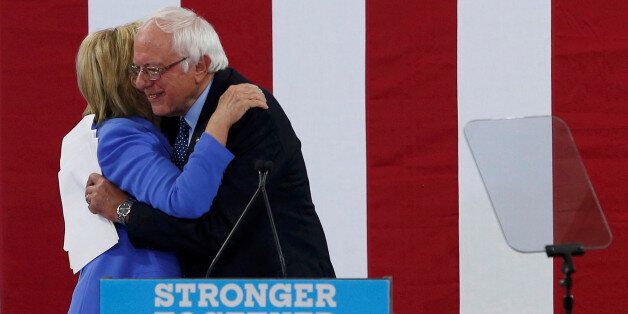 Democratic U.S. presidential candidate Hillary Clinton and Senator Bernie Sanders embrace during a campaign rally where Sanders endorsed Clinton in Portsmouth, New Hampshire, U.S., July 12, 2016. REUTERS/Mary Schwalm TPX IMAGES OF THE DAY