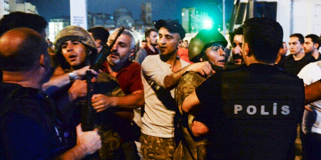 Turkish soldiers, arrested by civilians, are handed to police officers, in Istanbul's Taksim square, early Saturday, July 16, 2016. Members of Turkey's armed forces said they had taken control of the country, but Turkish officials said the coup attempt had been repelled early Saturday morning in a night of violence, according to state-run media. (AP Photo/Selcuk Samiloglu)