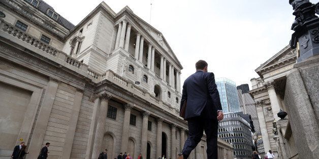 Pedestrians walk past the Bank of England (BOE) ahead of the bank's financial stability report news conference in the City of London, U.K., on Tuesday, July 5, 2016. The Bank of England cut its capital requirements for U.K. banks and pledged to implement any other measures needed to shore up financial stability after Britain's shock decision to leave the European Union. Photographer: Chris Ratcliffe/Bloomberg via Getty Images