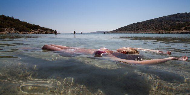 A girl floating in the water in the Greek island of Lipsi