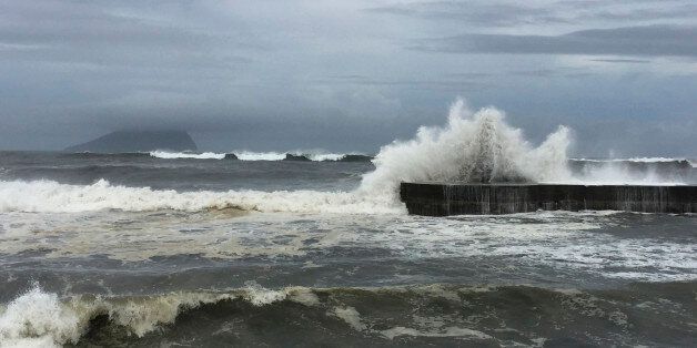 As fast-moving Typhoon Nepartak makes its way across the Philippines Sea, large waves crash against the breakwaters in Ilan County, eastern coast of Taiwan, Thursday, July 7, 2016. Nepartak is expected make landfall early Friday. (AP Photo/Johnson Lai)