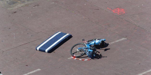 This picture taken on July 15, 2016, shows a a velo bleu (Nice's self-service bicycles) left behind on the site where a truck drove into a crowd watching a fireworks display on the Promenade des Anglais seafront in the French Riviera town of Nice on July 15, 2016.An attack in Nice where a man rammed a truck into a crowd of people left 84 dead and another 18 in a 'critical condition', interior ministry spokesman Pierre-Henry Brandet said Friday. An unidentified gunman barrelled the truck two kilometres (1.3 miles) through a crowd that had been enjoying a fireworks display for France's national day before being shot dead by police. / AFP / Valery HACHE (Photo credit should read VALERY HACHE/AFP/Getty Images)
