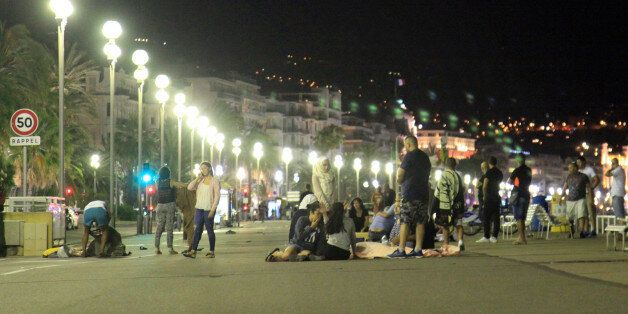 ATTENTION EDITORS - VISUAL COVERAGE OF SCENES OF INJURY OR DEATH - Blankets cover the dead and injured after a heavy truck ran into a crowd at high speed killing scores celebrating the July 14, 2016 Bastille Day national holiday on the Promenade des Anglais in Nice, France. Picture taken July 14, 2016. REUTERS/Tarubi Wahid Mosta