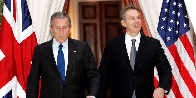 U.S. President George W. Bush (L) and British Prime Minister Tony Blair walk together from their meeting at the U.S. Embassy in Brussels, February 22, 2005. REUTERS/Kevin Lamarque/File Photo