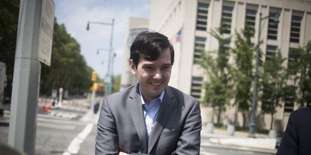 Martin Shkreli, former chief executive officer of Turing Pharmaceuticals LLC, smiles while exiting federal court in the Brooklyn borough of New York, U.S., on Thursday, July 14, 2016. A federal judge scheduled the former pharmaceutical executive to be tried on June 26, 2017, in a securities fraud case. Photographer: John Taggart/Bloomberg via Getty Images