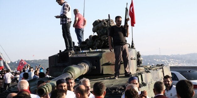 ISTANBUL, TURKEY - JULY 16: Turkish people are seen over the tank after a group of soldiers with armored vehicle, involved in 'Parallel State/Gulenist Terrorist Organization's coup attempt, are being neutralized by police at Bosphorus Bridge in Istanbul, Turkey on July 16, 2016 while people are reacting against military coup attempt. Parallel state is an illegal organization backed by U.S.-based preacher Fetullah Gulen. (Photo by Elif Ozturk/Anadolu Agency/Getty Images)