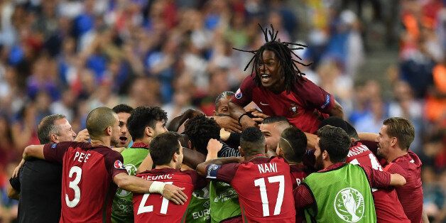 PARIS, FRANCE - JULY 10: Renato Sanches (top) and Portugal players celebrate their team's first goal scored by Eder (obscured) during the UEFA EURO 2016 Final match between Portugal and France at Stade de France on July 10, 2016 in Paris, France. (Photo by Laurence Griffiths/Getty Images)
